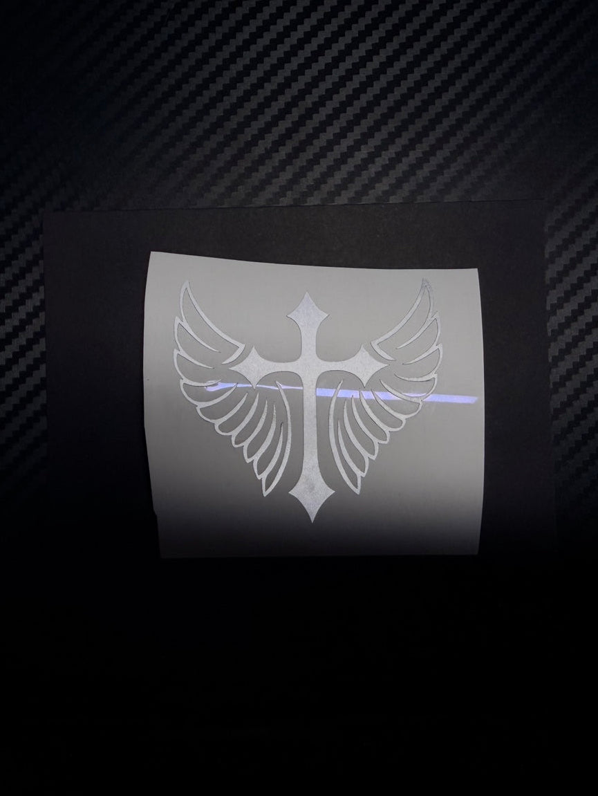 Custom cross-and-wings vinyl decal example on backing paper