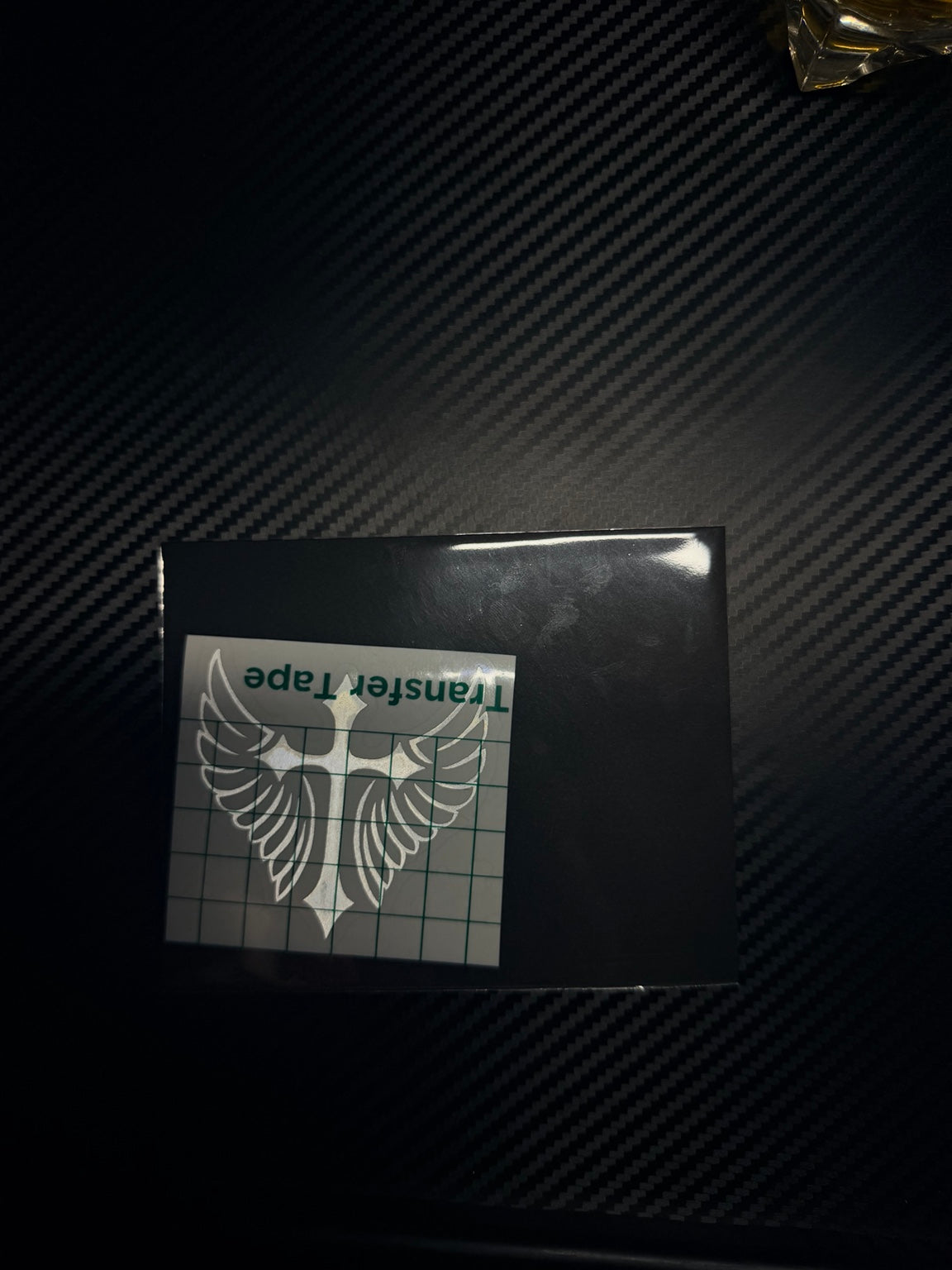 Custom cross-and-wings decal with transfer tape and packaging