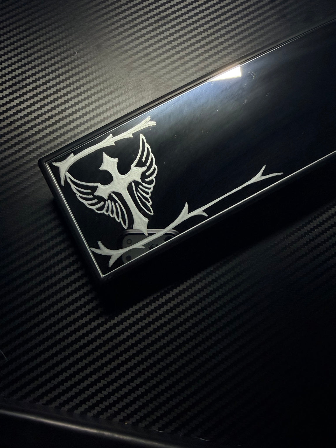 Hand-engraved cross and wings detail